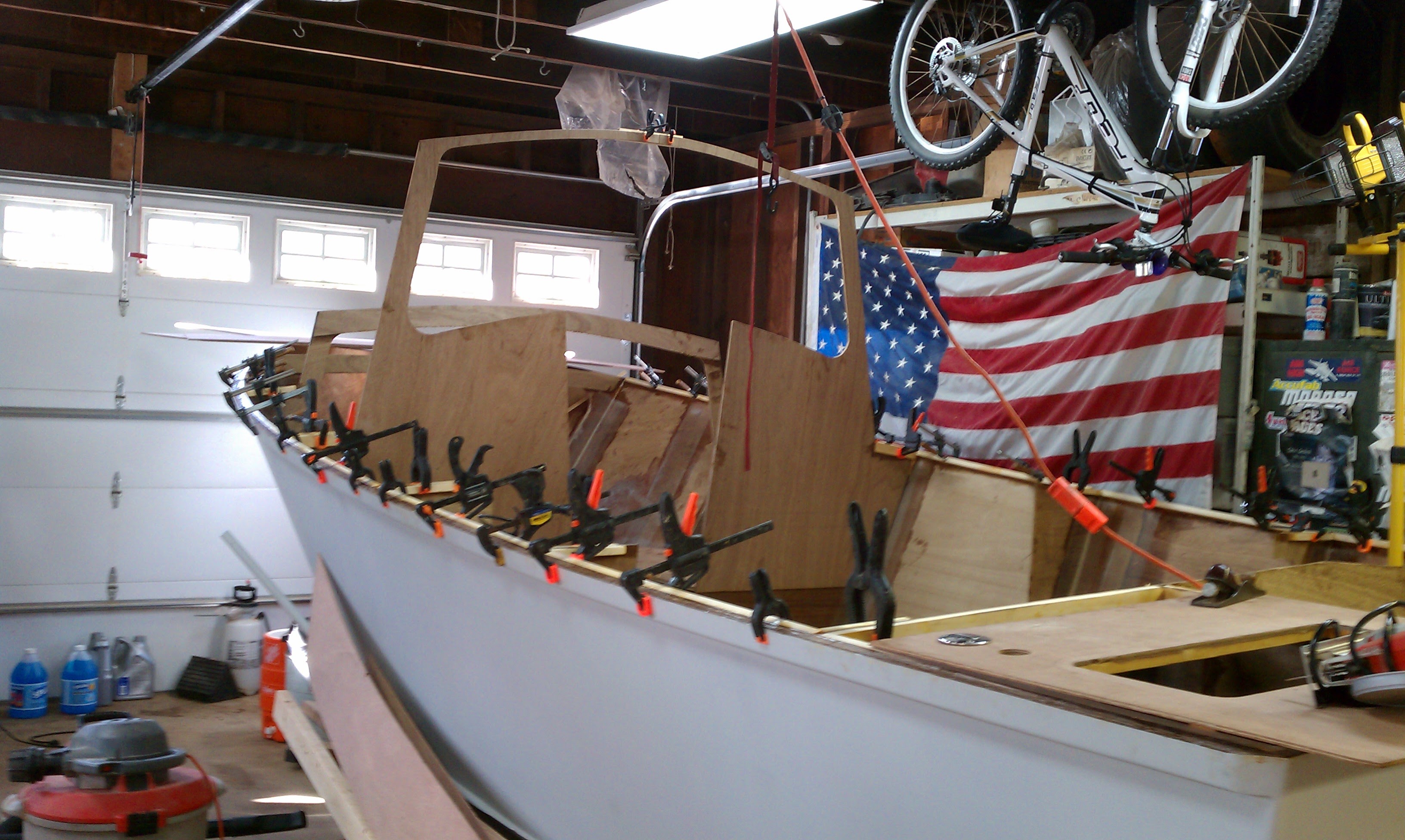 Hull with cabin, dozens of clamps on gunwale