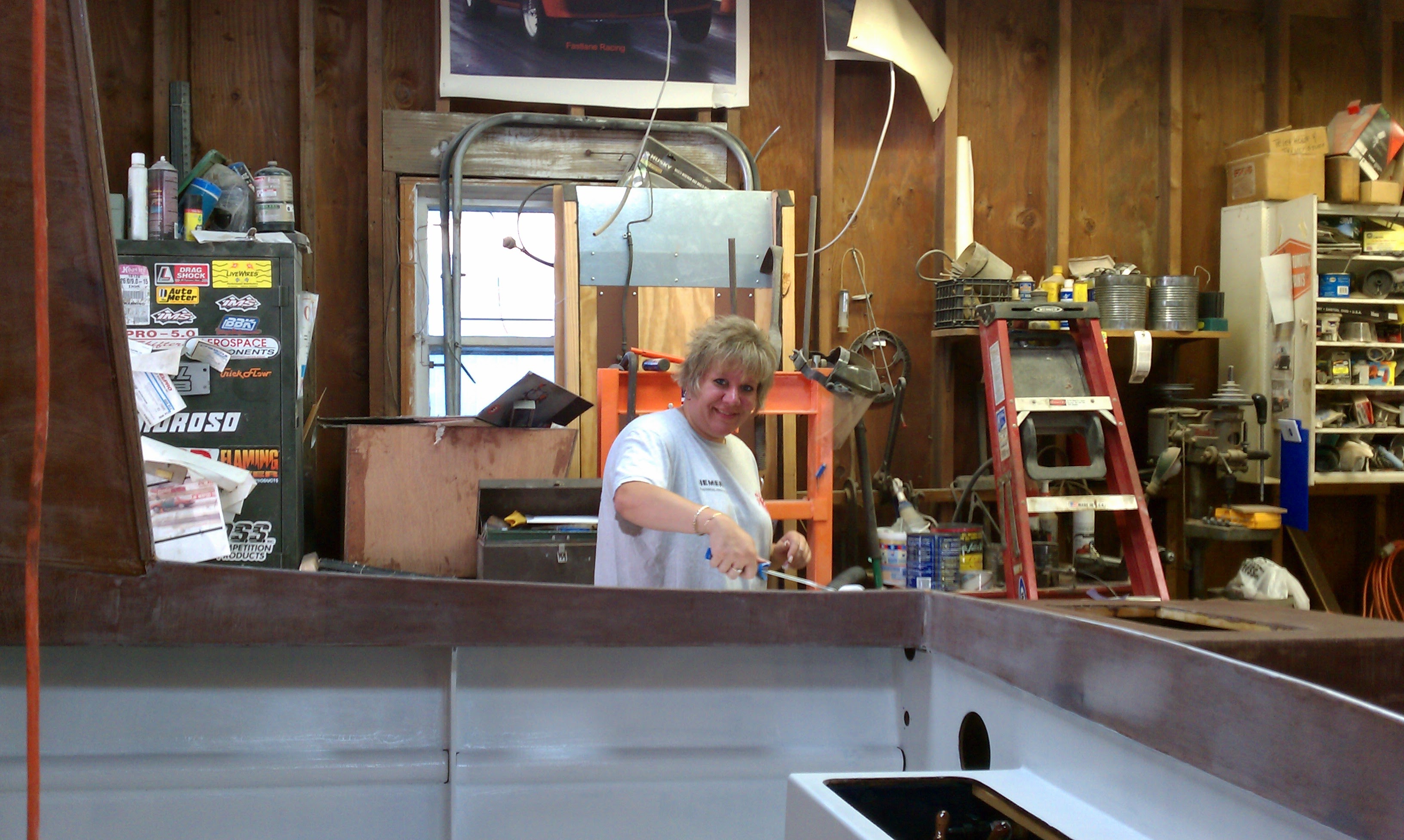 Joanne Palmer working on the boat in the garage