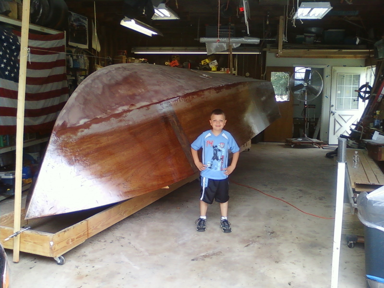 Young Dominic standing in front of the hull