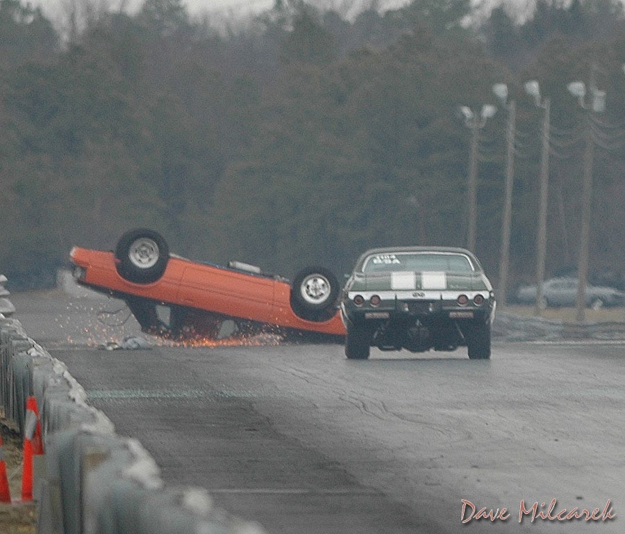 Car inverted, sparks and fire underneath