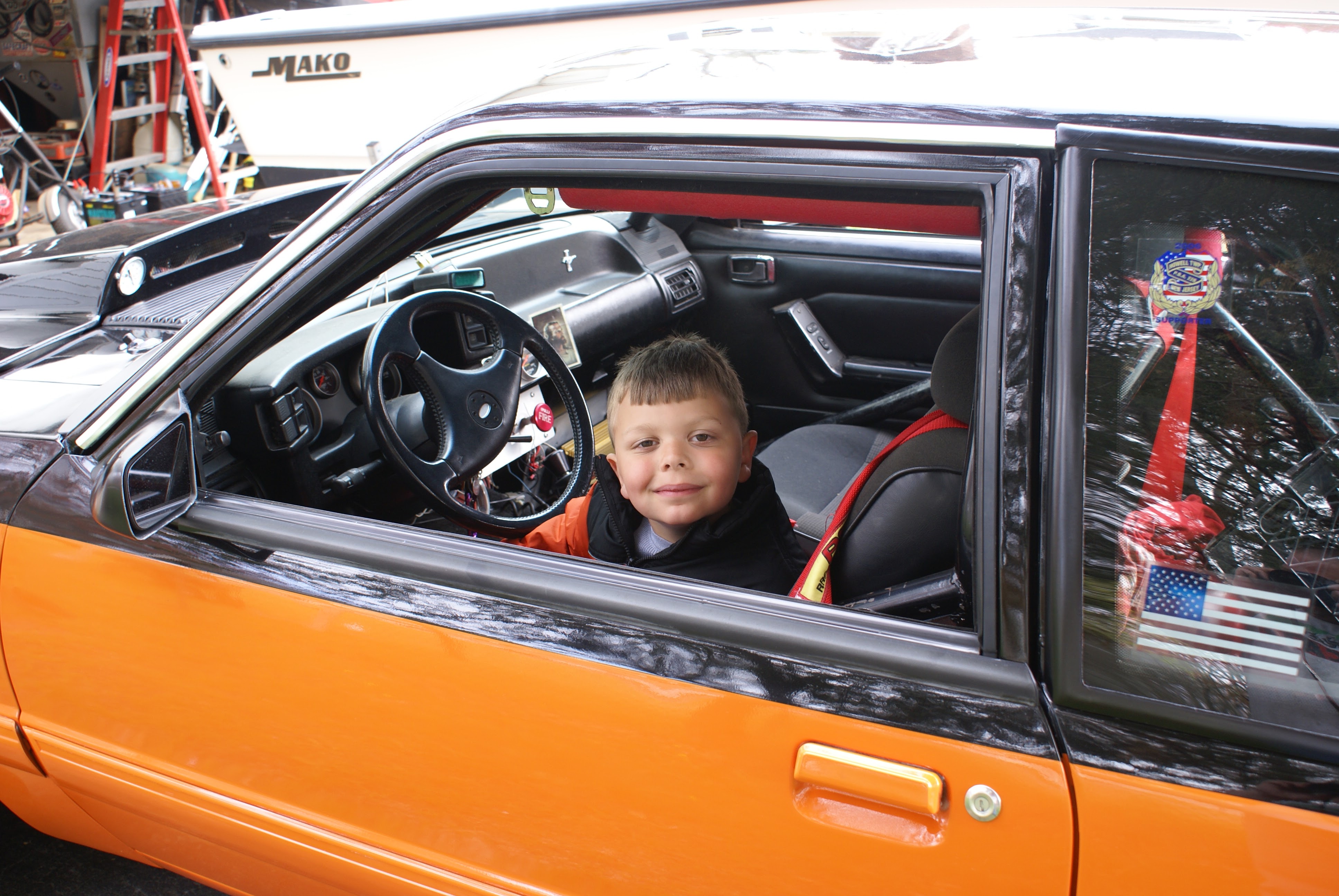 A five-year-old Dominic sitting in the 88 Fox body Mustang