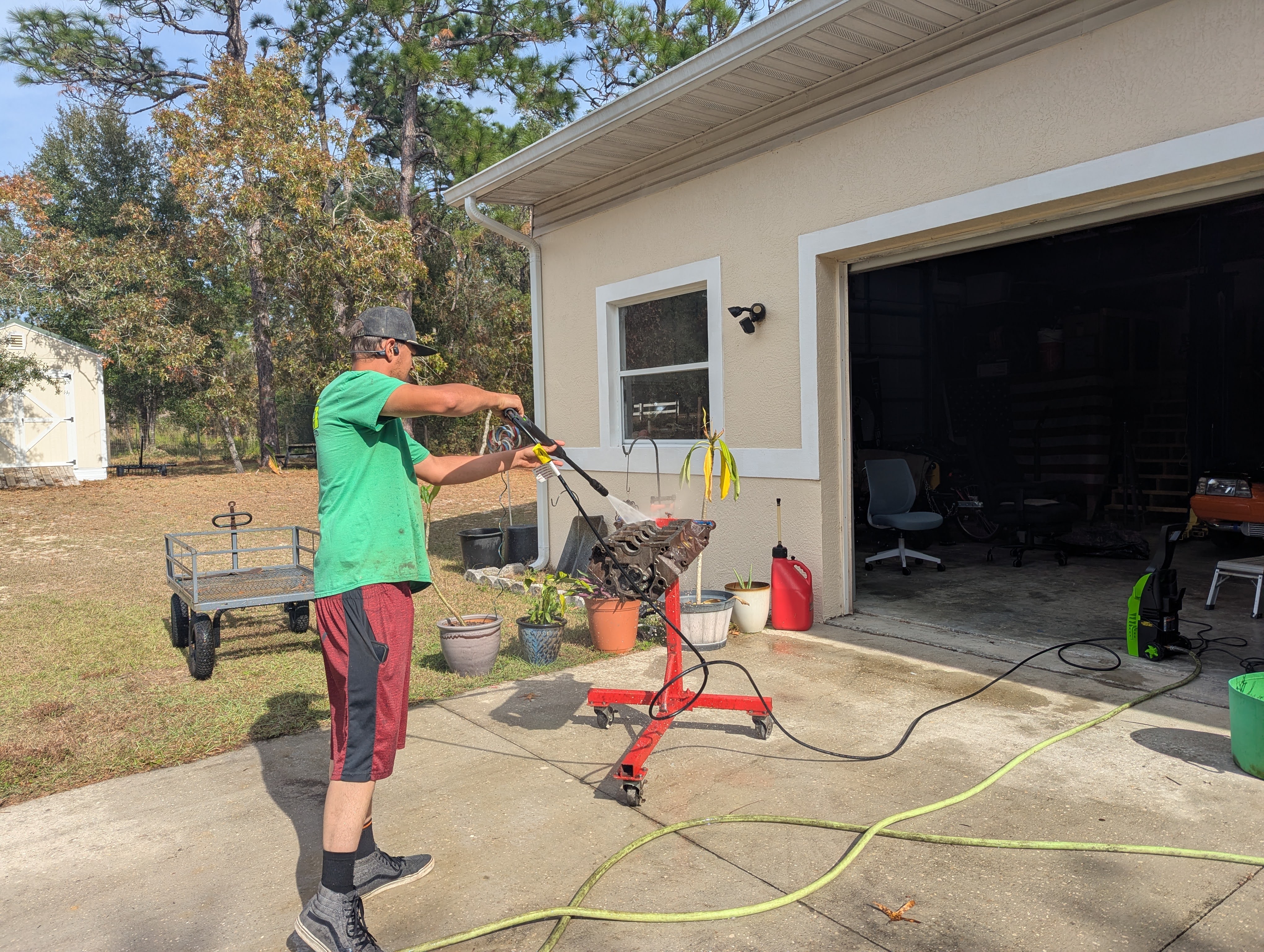 Dominic pressure washing the block outside