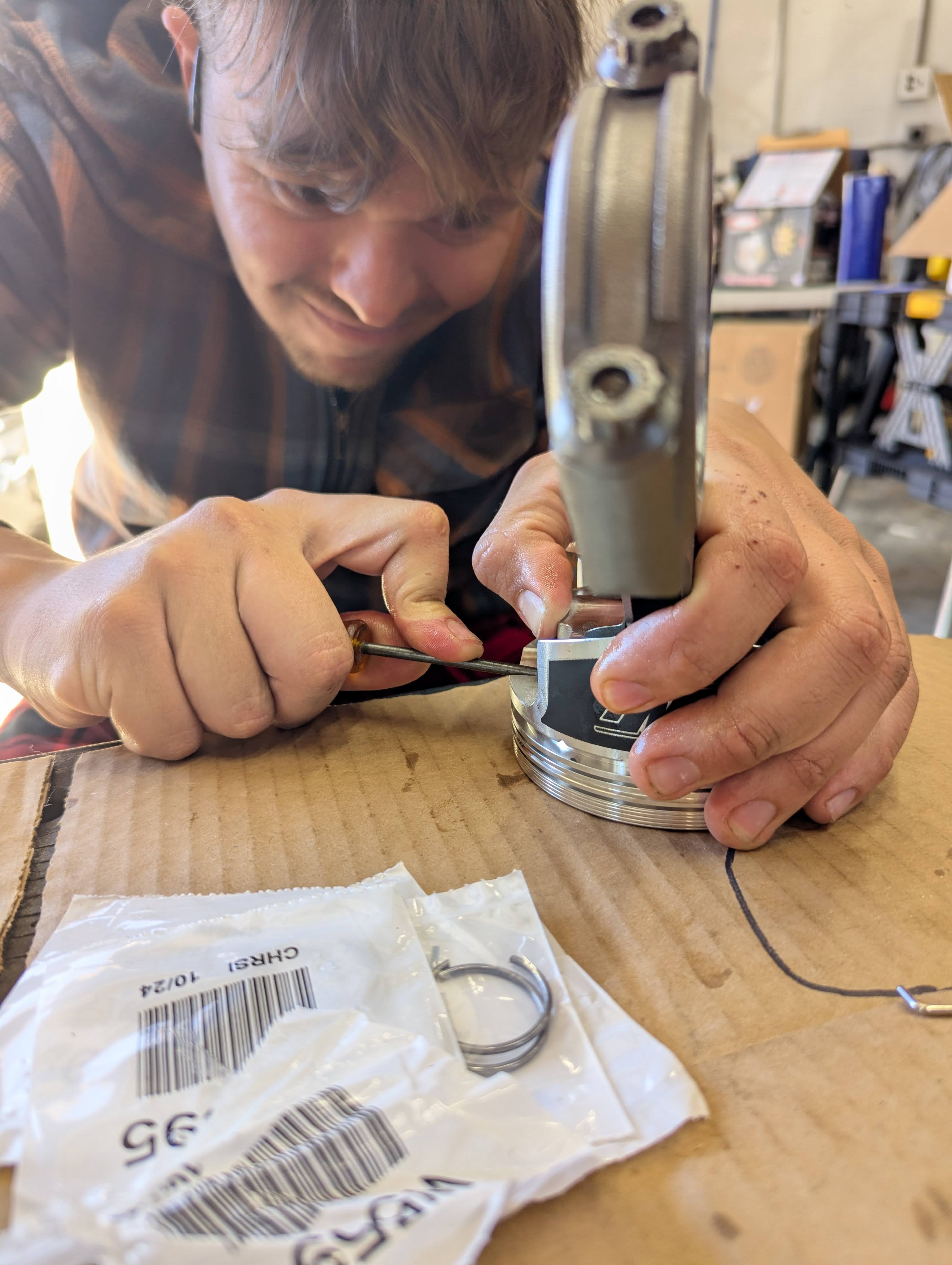 Dominic fitting piston rings close-up