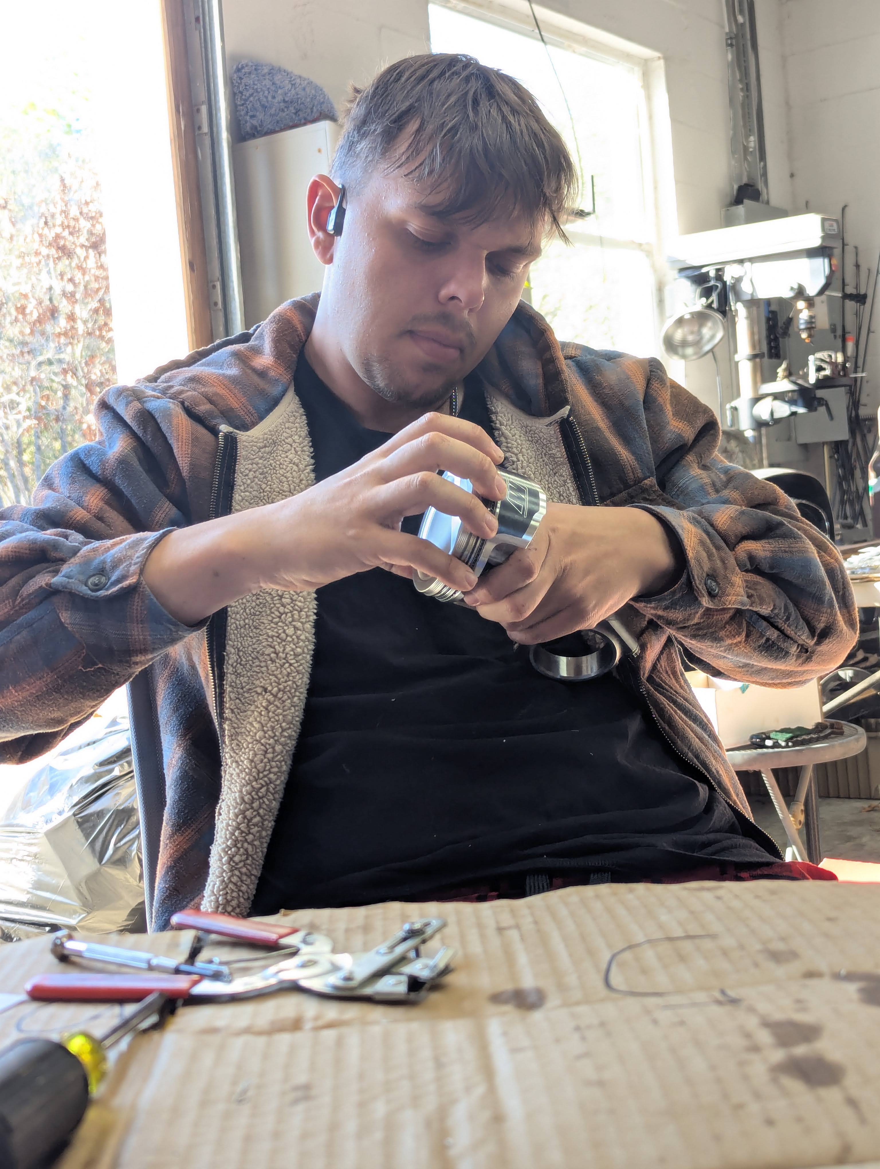 Dominic holding a piston assembly