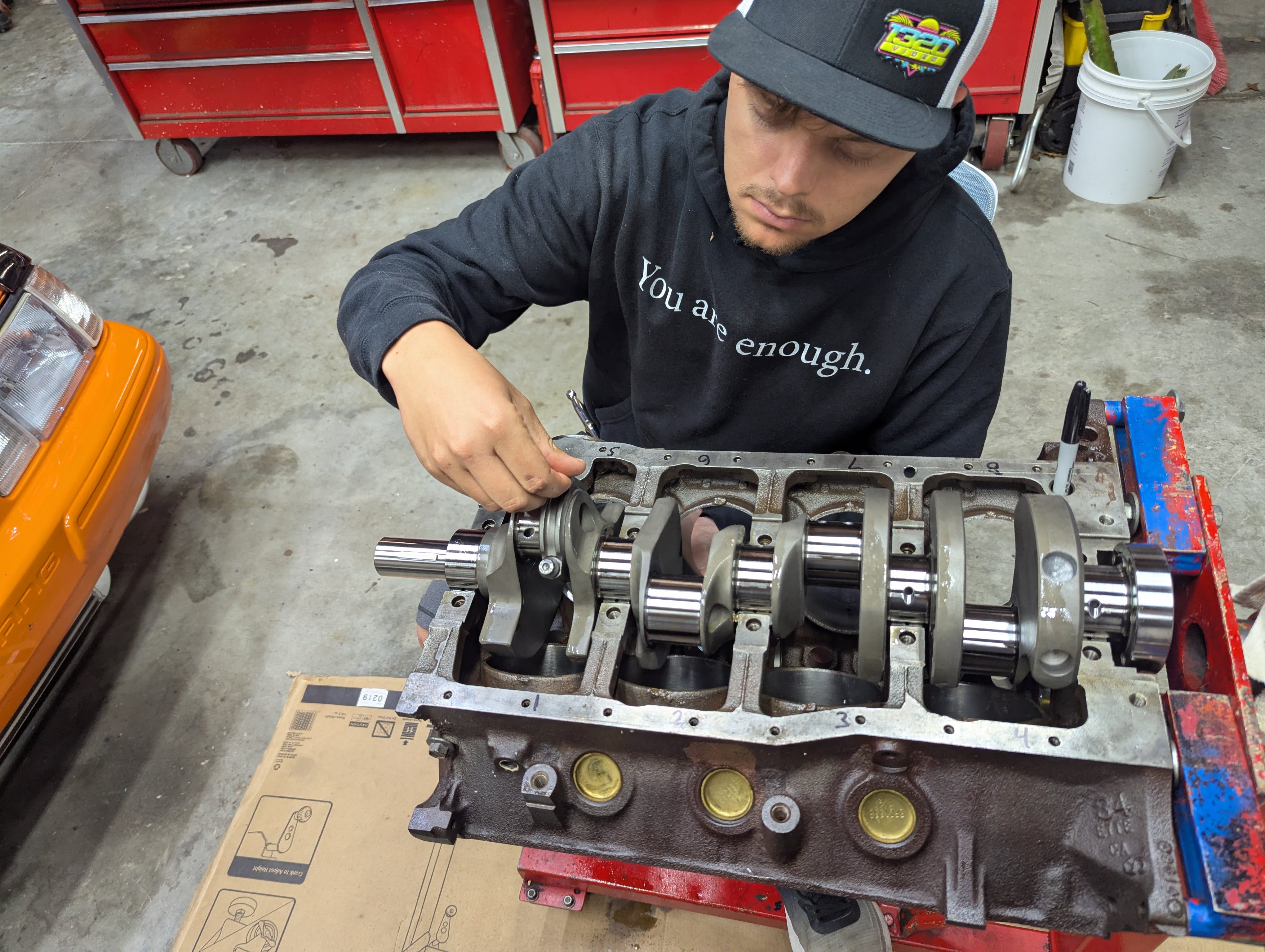 Crankshaft going in, orange Mustang in background